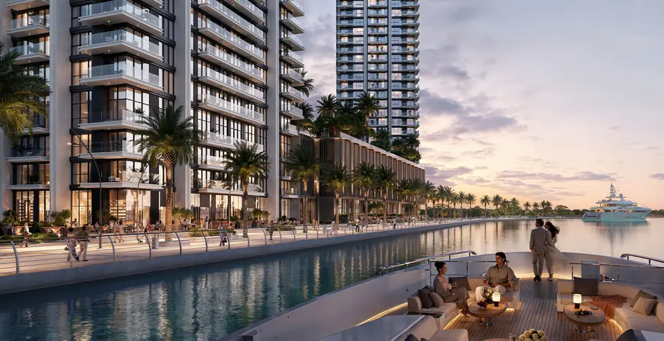 Creek Bay — the waterfront terrace at dusk below the towers, render (Emaar)