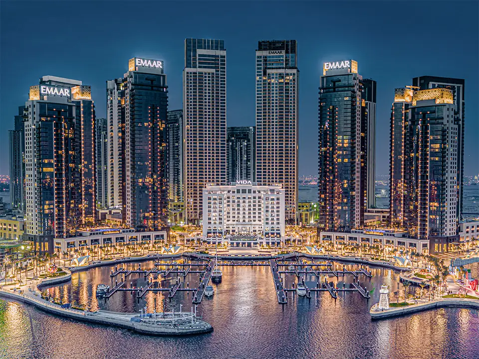 Dubai Creek Residences — the towers above Creek Marina at night, photo (Emaar)